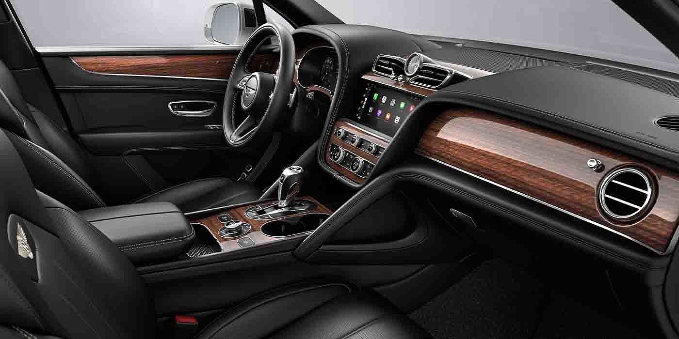 Bentley Maastricht Bentley Bentayga EWB interior with a Crown Cut Walnut veneer, view from the passenger seat over looking the driver's seat.