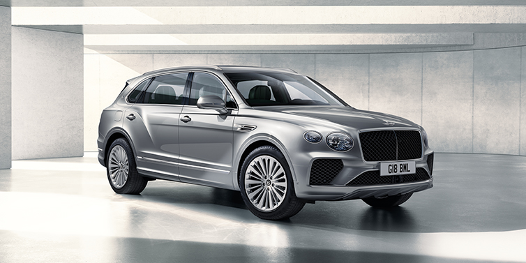 Bentley Maastricht Bentley Bentayga Extended Wheelbase SUV front three quarter in Moonbeam paint with a grey background
