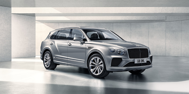 Bentley Maastricht Bentley Bentayga Extended Wheelbase SUV front three quarter in Moonbeam paint with a grey background