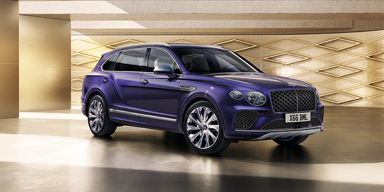 Bentley Maastricht Bentley Bentayga Extended Wheelbase Mulliner SUV front three quarter in Tanzanite Purple paint with a gold patterned background