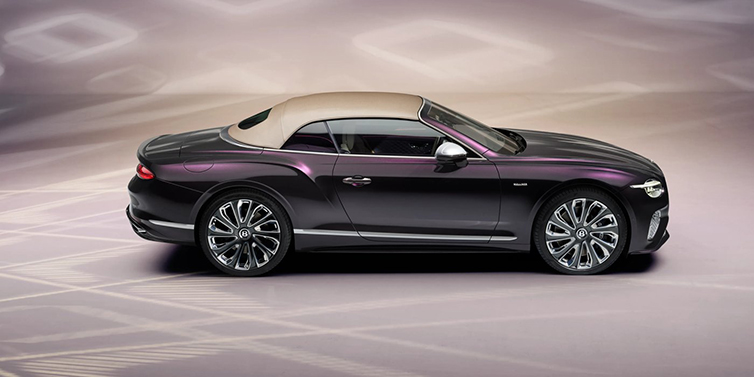 Bentley Maastricht Bentley Continental GTC Mulliner convertible in profile with hood up, in Tanzanite Purple paint and 22 inch Mulliner painted and polished wheels