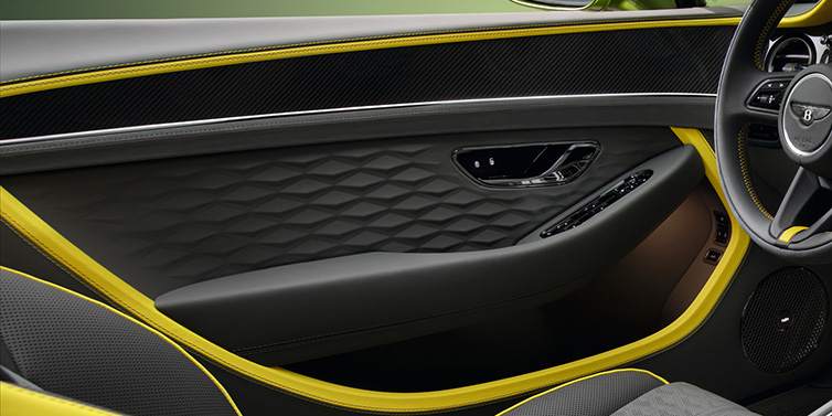 Bentley Maastricht Bentley Continental GTC Speed convertible interior door details featuring Gravity Grey and Cyber Yellow by Mulliner hides and high gloss carbon fibre veneer