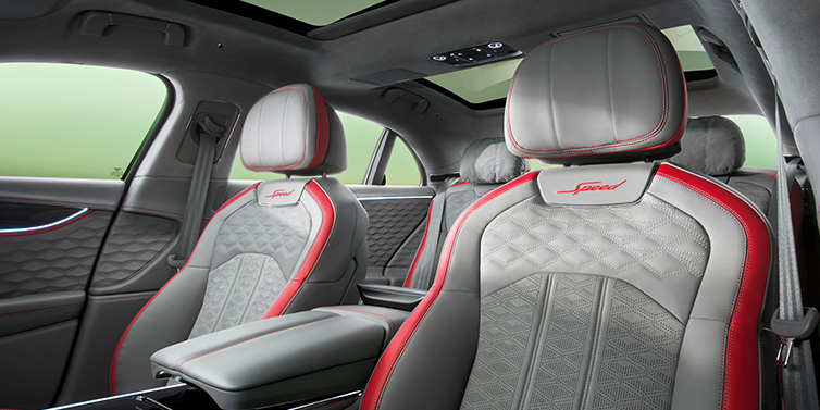 Bentley Maastricht Bentley Flying Spur Speed sedan interior showing front and rear seats in Hotspur red and Gravity Grey hides, with Speed seat emblems