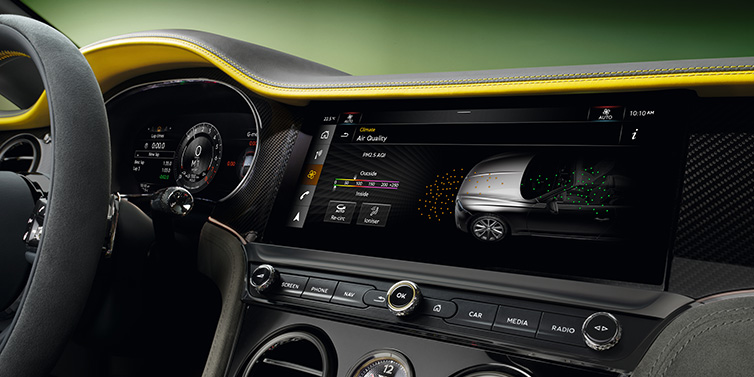 Bentley Maastricht Bentley Continental GTC Speed convertible front interior centre console with MMI screen showing Air Quality visualisation surrounded by Cyber Yellow by Mulliner and Gravity Grey hides and high gloss carbon fibre veneer