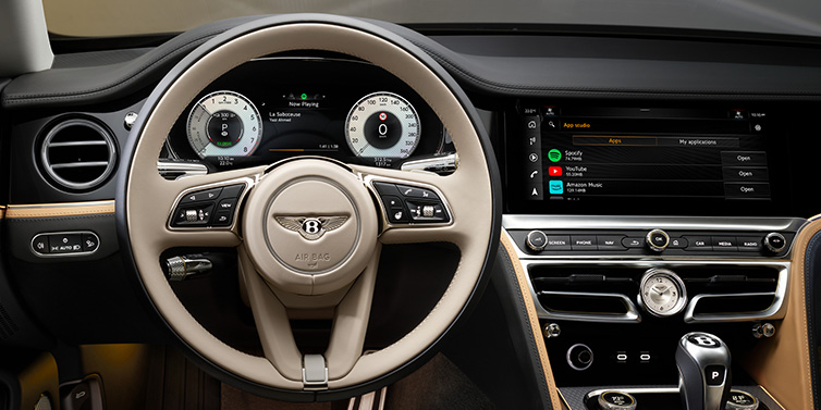 Bentley Maastricht Bentley Flying Spur Mulliner sedan front interior detail of steering wheel and driver screens surrounded by Linen and Beluga black hides