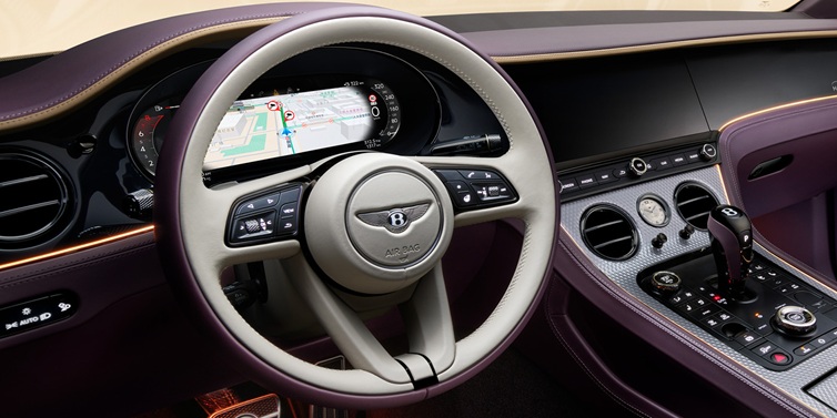 Bentley Maastricht Bentley Continental GT Mulliner coupe front interior showing steering wheel and drivers screens surrounded by Linen and Damson hides and Grand Black veneer